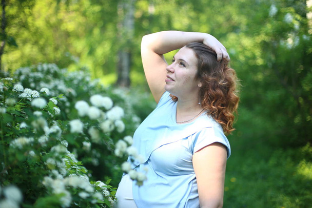 happy pregnant beautiful girl with curly  ginger hair - Photo, Image