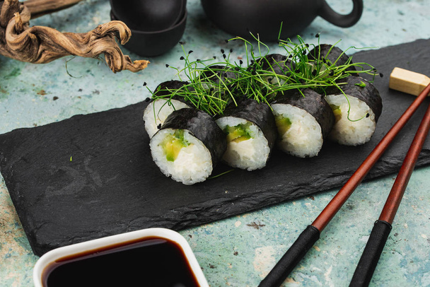 Closeup of fresh sushi on black stone platter - Fotoğraf, Görsel