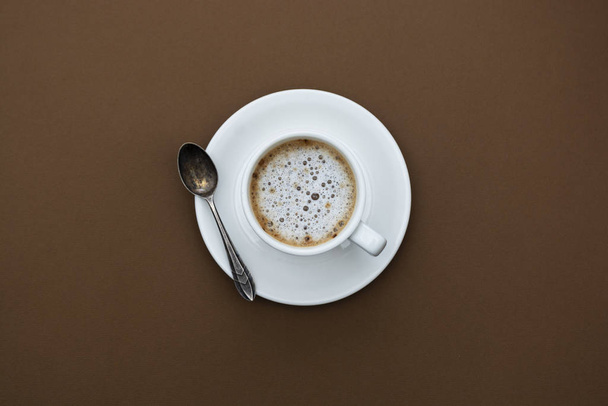 Coffee cup isolated on brown table. Top view, flat lay black coffee drink with copy space. - Foto, Imagen
