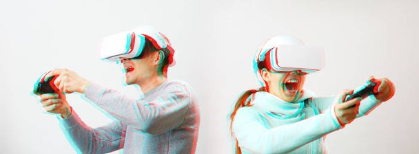 Man and woman with virtual reality headset are playing game. Image with glitch effect. - Photo, Image