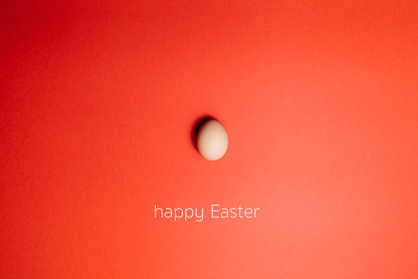Fresh egg on a Red background. Happy Easter - Foto, Bild