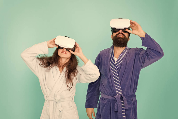morning start with future technology. digital couple. innovation in family relations. create your reality. New world of virtual reality. family couple wear vr headset. girl and man relax in bathrobe - Zdjęcie, obraz