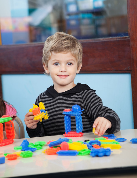 Boy Playing With Blocks In Kindergarten - Фото, изображение