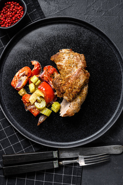 Roast Turkey thigh fillet with vegetables. Black background. Top view - 写真・画像