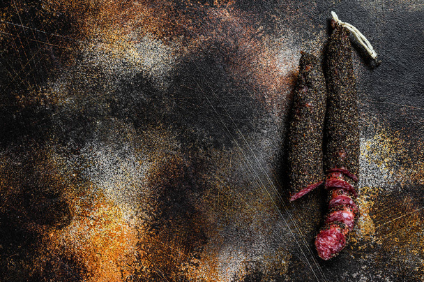 Fuet, Salami. Traditional Spanish sausage. Black background. Top view. Space for text - Foto, Bild