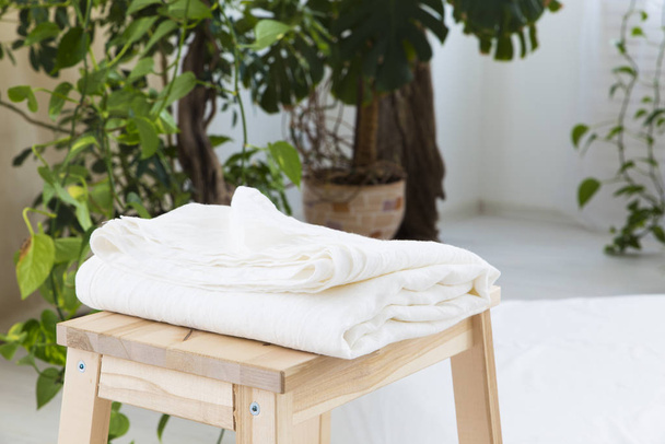 natural eco-friendly linen bed in the interior - 写真・画像