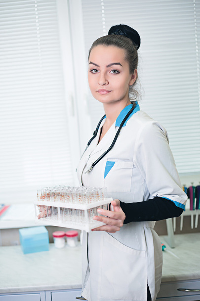 A portrait of sexy beautiful midicine nurse doctor in a white gown - Foto, immagini