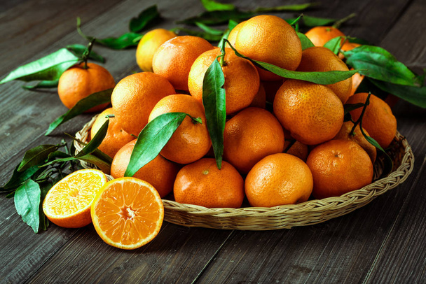 Fresh oranges on a wooden table - Foto, afbeelding