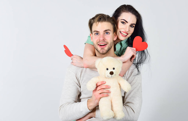Valentines day concept. Valentines day and love. Romantic ideas celebrate valentines day. Man and woman couple in love hold red heart valentines cards white background. Man and pretty girl in love - Valokuva, kuva