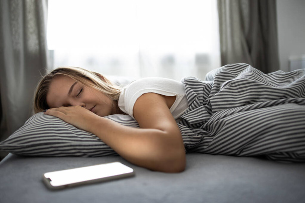 Pretty, young woman sleeping in her bed  - Фото, зображення