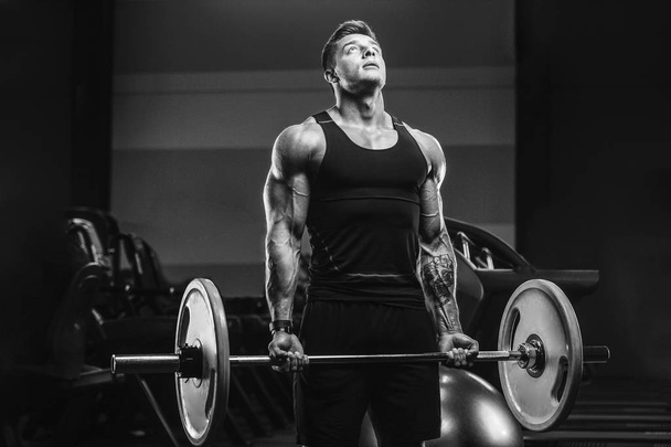 Handsome strong athletic men pumping up biceps muscles workout f - 写真・画像