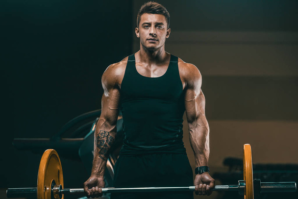 Handsome strong athletic men pumping up biceps muscles workout f - 写真・画像