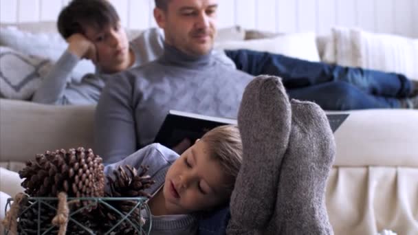 Family with three children is spending time together at home in Christmas eve. - Materiał filmowy, wideo