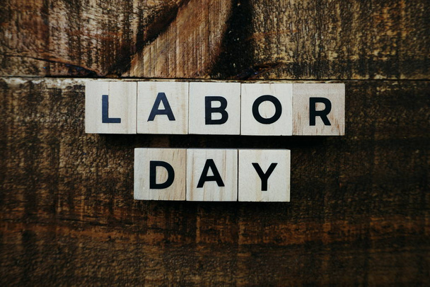 Top view labor day letters alphabet wooden cubes on wooden background - Photo, Image
