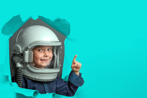 Small child wants to fly an airplane wearing an airplane helmet - Foto, imagen