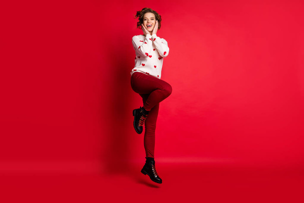 Full length body size view of her she nice attractive lovely charming girlish feminine modest cheerful cheery glad girl having fun jumping celebrating isolated on bright vivid shine vibrant red color - Foto, Imagem