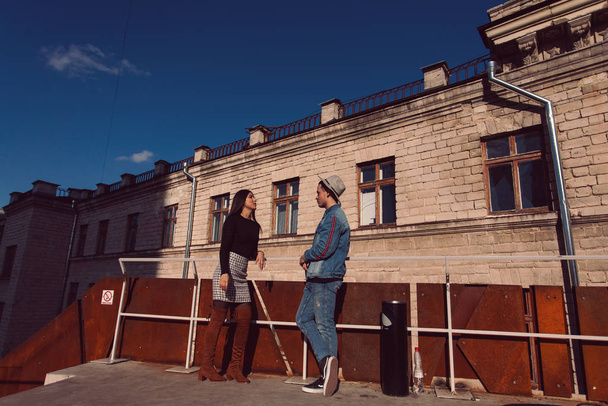 Stylish guy and girl posing in front of the camera on the street. - Valokuva, kuva