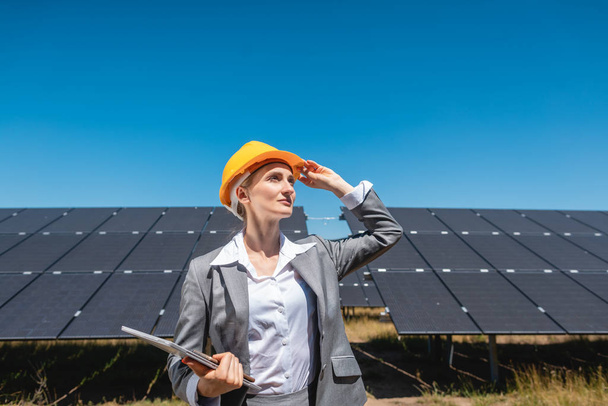 Business woman or investor inspecting her solar farm - Valokuva, kuva
