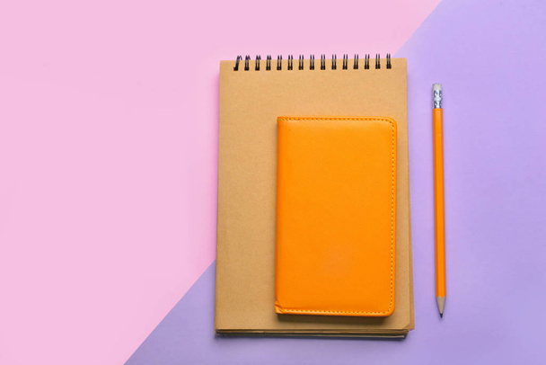 Stylish notebooks with pencil on color background - Photo, Image