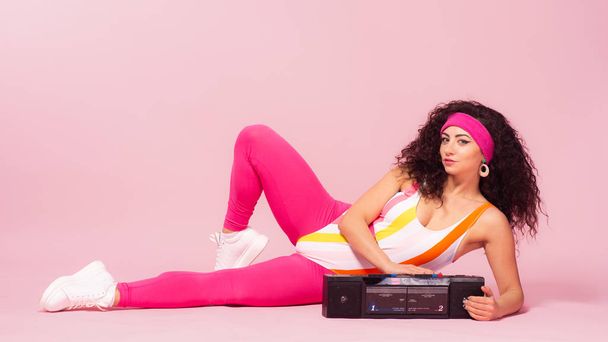 Color background with sport girl, 80s, aerobic. Toned photo - Photo, Image