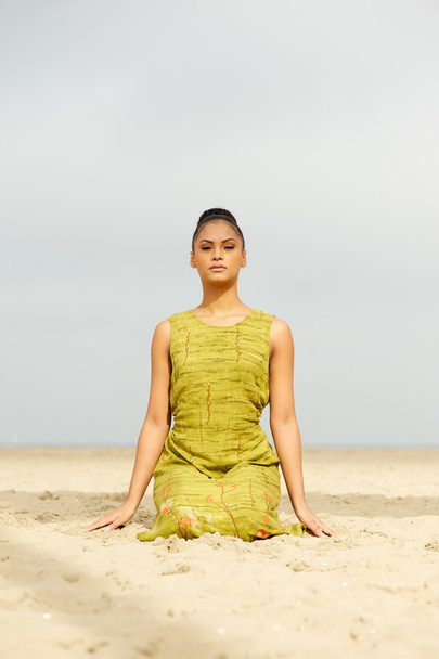 Beautiful woman meditating at the beach - Fotó, kép