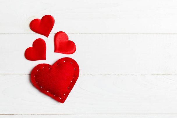 Vista superior de corações têxteis vermelhos em fundo de madeira com espaço de cópia. Conceito romântico. Dia de São Valentim
 - Foto, Imagem