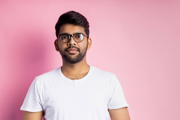 Portrait of handsome Indian guy standing on pink background - Foto, immagini