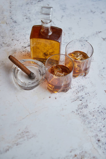Bottle and glasses of brandy or wiskey and nice big cuban cigar - Photo, Image