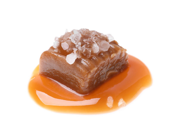 Delicious salted caramel with sauce on white background - Zdjęcie, obraz