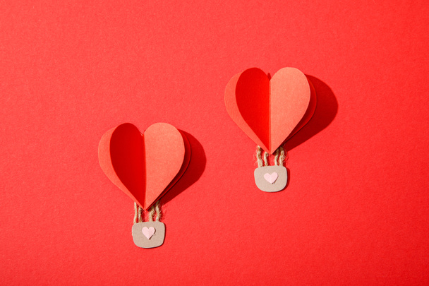 top view of paper heart shaped air balloons with locks on red background - Foto, immagini