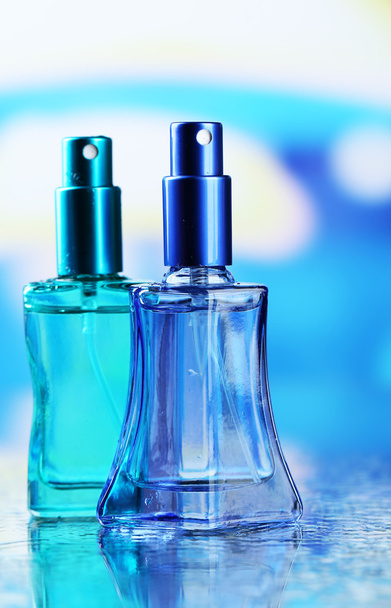 Women perfume in beautiful bottles on bright background - Foto, afbeelding