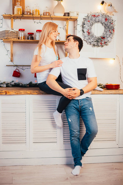 beautiful happy young couple in kitchen at christmastime - Foto, Imagem