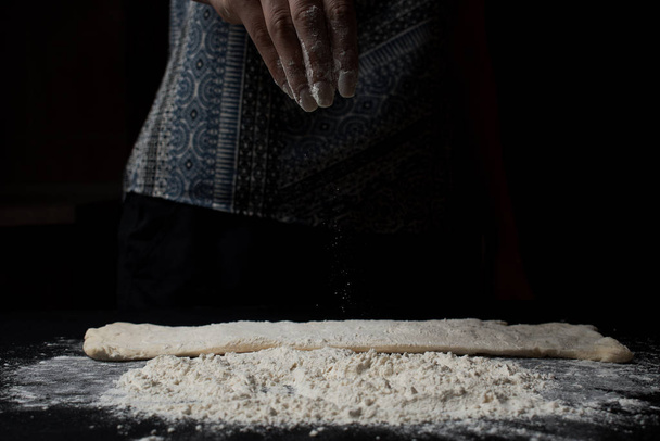 partial view of woman sifting flour and preparing dough  - Фото, изображение