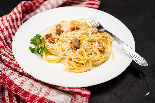 Carbonara pasta, spaghetti with pancetta, egg, hard parmesan cheese and cream sauce. Traditional italian cuisine. Close-up view  - Φωτογραφία, εικόνα