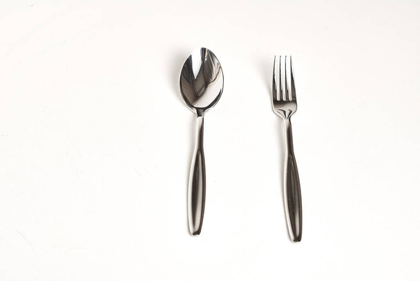 collection of shiny cutlery on white background, top view   - Photo, Image