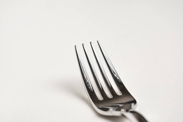 close-up view of shiny silver fork on white background  - Fotografie, Obrázek