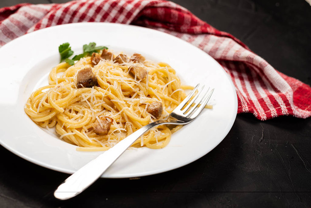 Carbonara pasta, spaghetti with pancetta, egg, hard parmesan cheese and cream sauce. Traditional italian cuisine. Close-up view  - Fotoğraf, Görsel