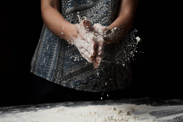 mid section of woman sifting flour and preparing dough - Fotó, kép