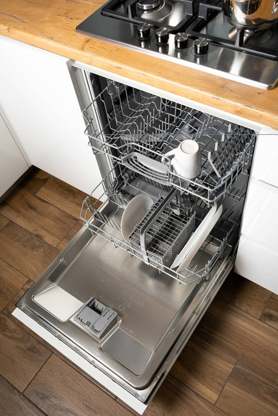 high angle view of open dishwasher in modern kitchen interior - Photo, Image