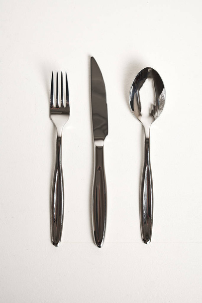 top view of spoon, fork and knife on white background - Fotoğraf, Görsel