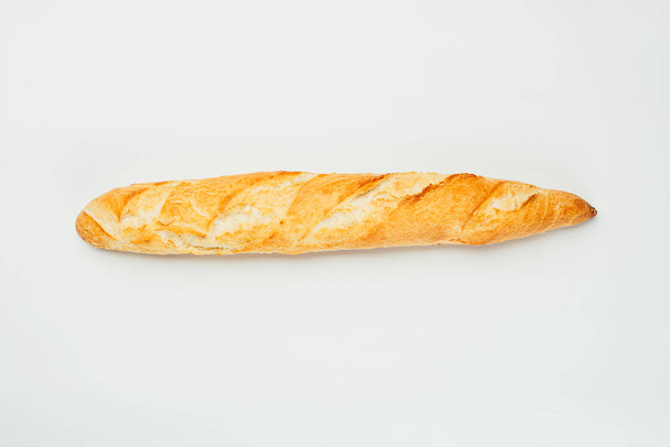 close-up view of delicious fresh homemade baguette on white background - Fotó, kép