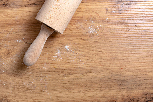 top view of rolling pin and flour on wooden table - Fotoğraf, Görsel