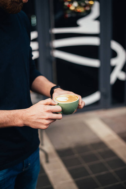 partial view of man holding cup of tasty cappuccino  - Photo, Image