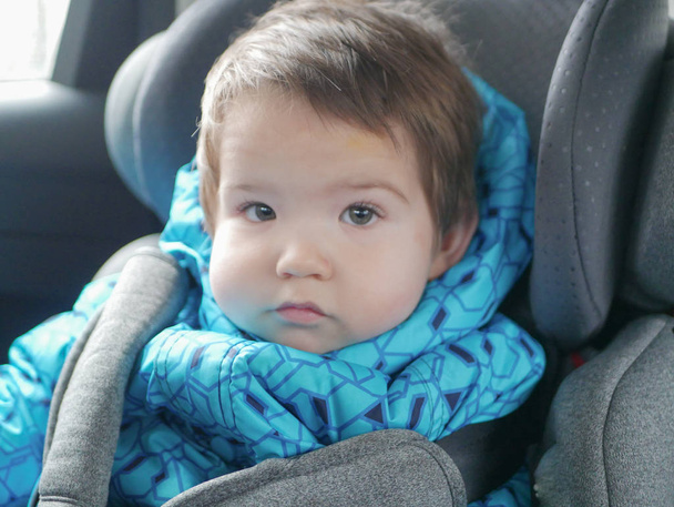 child in a car seat. Child safety in the childs car seat during sleep. - Photo, Image