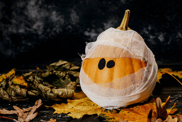 Zombie pumpkins in bandages, on a dark background. The concept o - Photo, Image