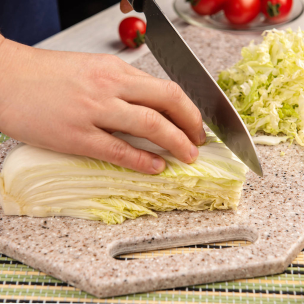 Chef prepares a dish of cabbage on a board of artificial stone - Photo, Image