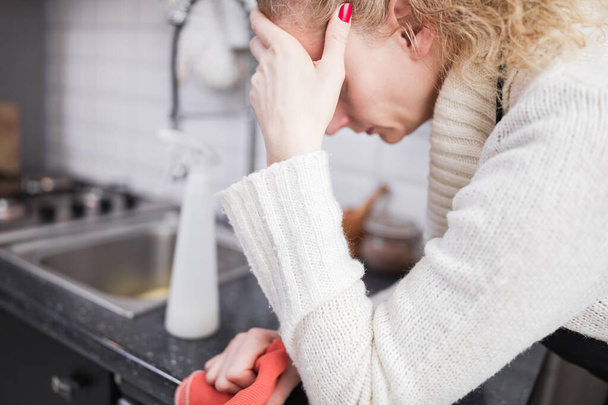 Woman tired from cleaning the house, kitchen and doing daily hou - Photo, Image