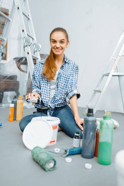 Peintre de maison femelle mélange des peintures dans le seau. Réparation de la maison, femme riante faisant rénovation de l'appartement, décoration de la chambre rénovant
 - Photo, image