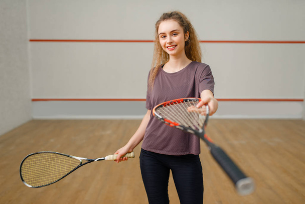 Female player gives squash racket. Girl on game training, active sport hobby on court, fit workout for healthy lifestyle - Photo, Image