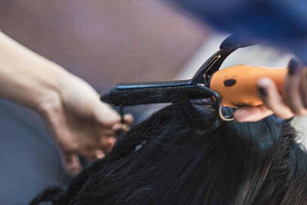 Curling women's curls black hair - Zdjęcie, obraz